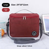 A maroon insulated portable lunch bag with a gray strap is shown on a white surface.