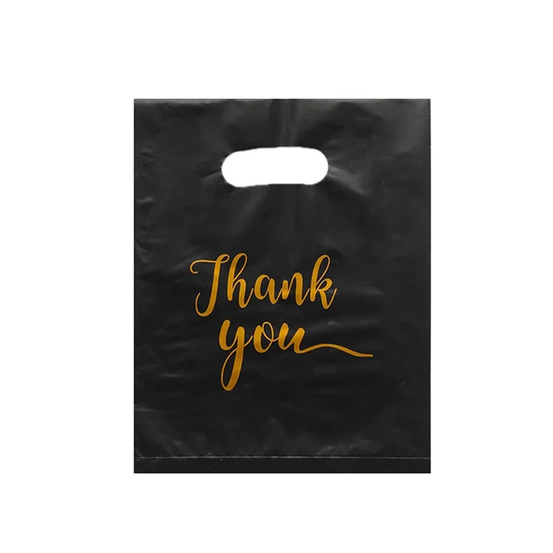 Black gift bag with gold script text that reads Thank you