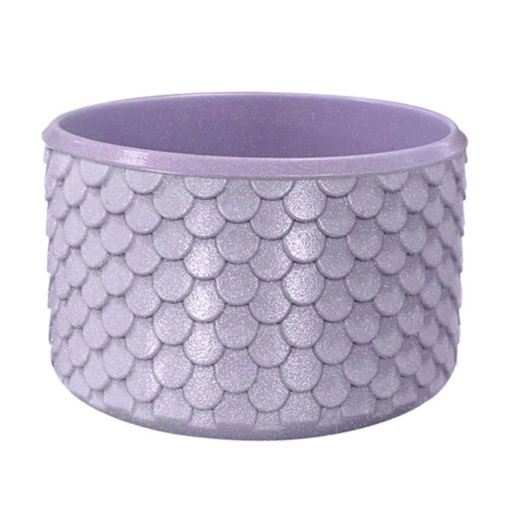 Purple silicone boot sleeve for water bottles with a textured, scale-like pattern