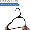 A black durable plastic non-slip clothing hanger being held by a hand.