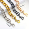 A collection of thick metal purse chain replacement straps in gold, silver, and black, shown laid out on a white surface.