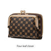 A dark brown leather accordion card holder wallet with a gold-toned clasp and a repeating four-leaf clover pattern.