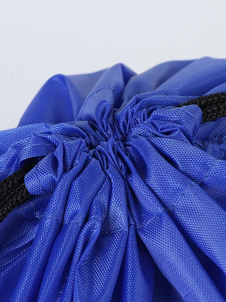 Blue gym drawstring backpack with multiple pockets shown in a close-up view.