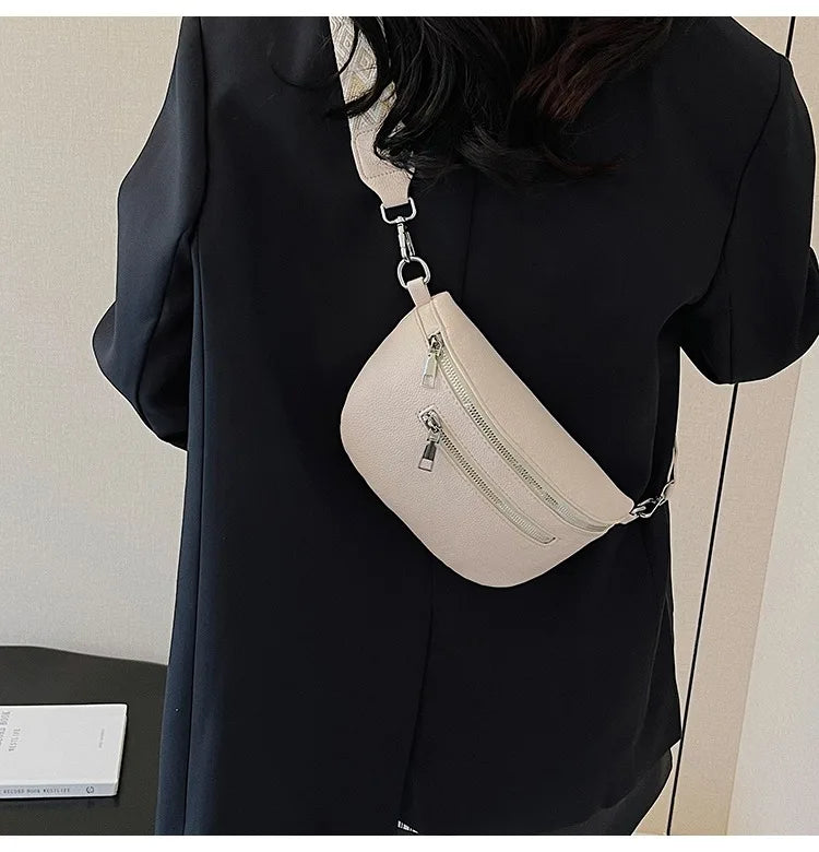 A beige PU leather multi-pocket crossbody bag is shown hanging from a black blouse.