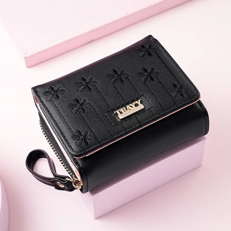 Black compact PU leather women's wallet with a zippered closure and decorative floral embossing