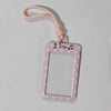 A pink polka dot card holder with a pink lanyard is shown against a white background.