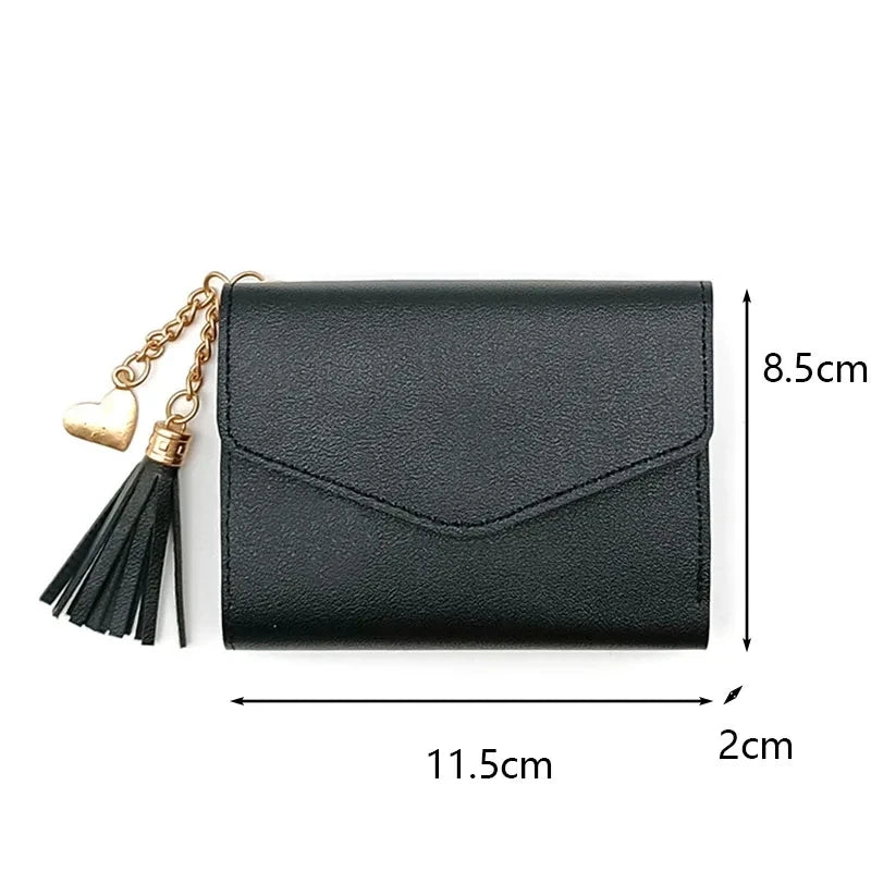 Black waterproof nylon crossbody bag with gold chain and tassel detail