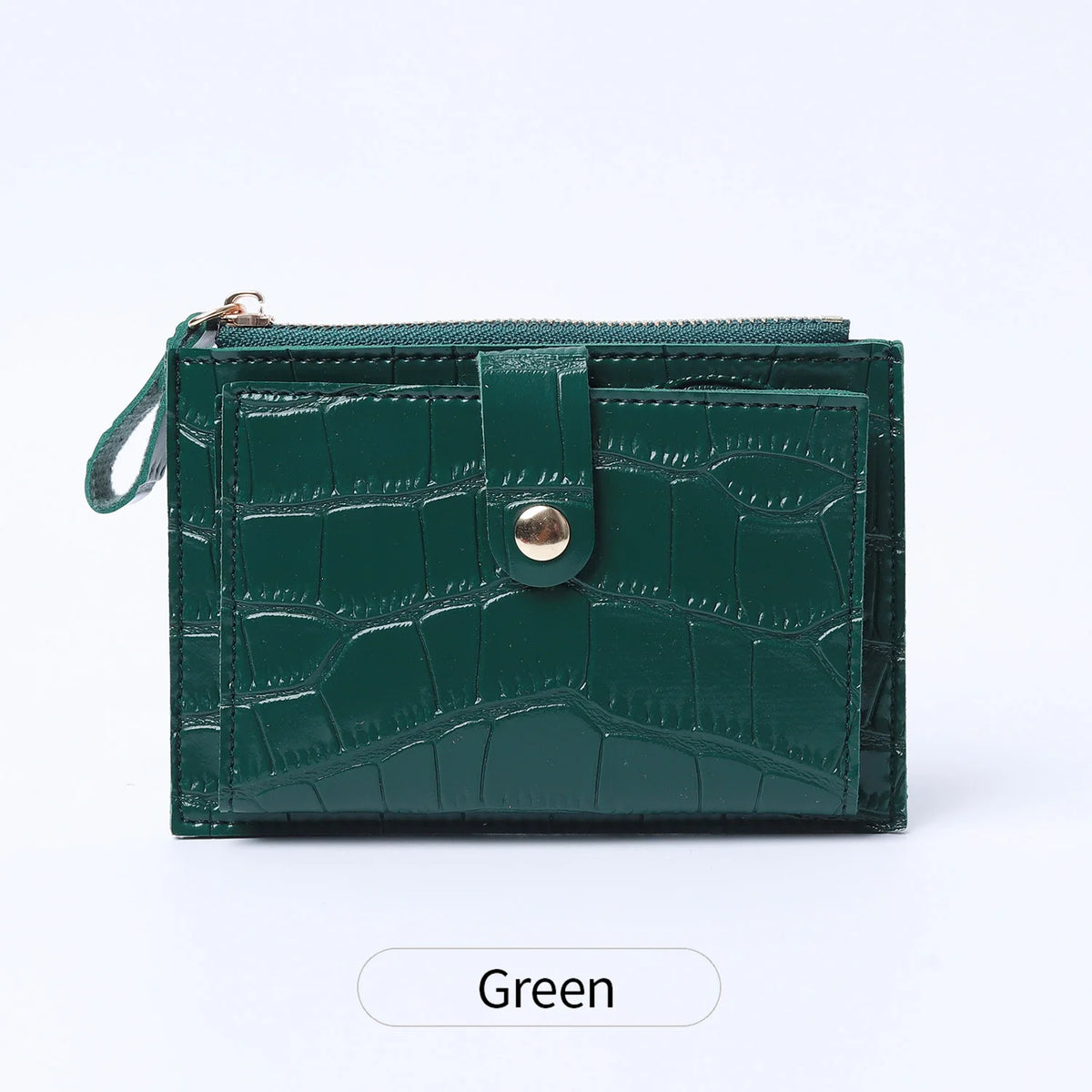A dark green mini crocodile pattern leather card holder with a zipper closure.