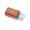 A brown leather minimalist wallet holding several credit cards and an ID card.
