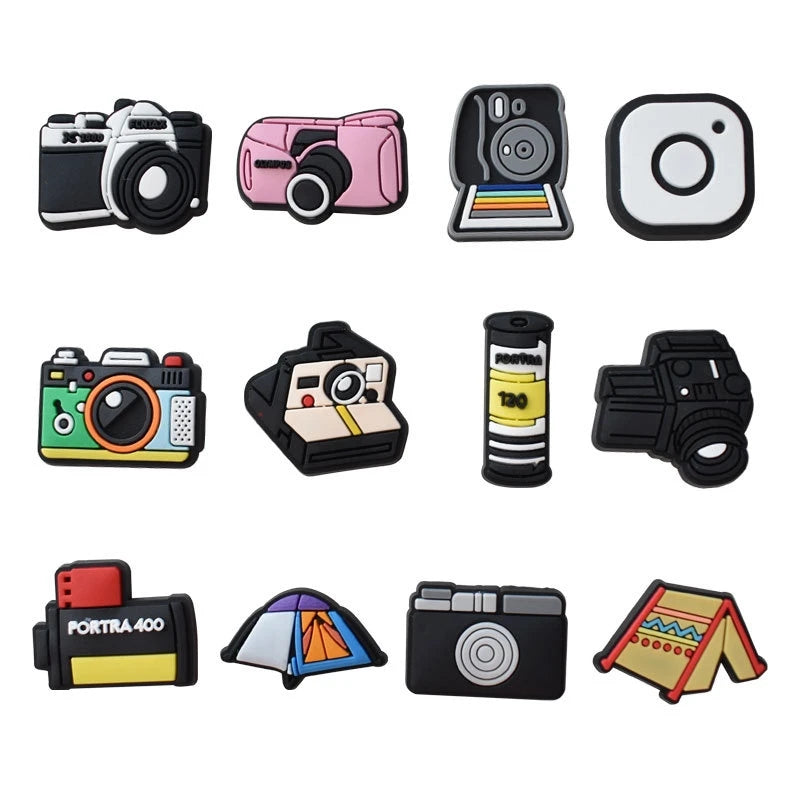 A collection of decorative shoe charms and pins for clogs and sandals, including camera-themed accessories.