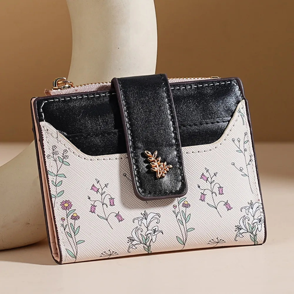 A black and white floral patterned PU leather slim card holder wallet with a black leather flap.