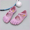 Pink women's barefoot five-toe shoes with an adjustable strap next to a baseball.