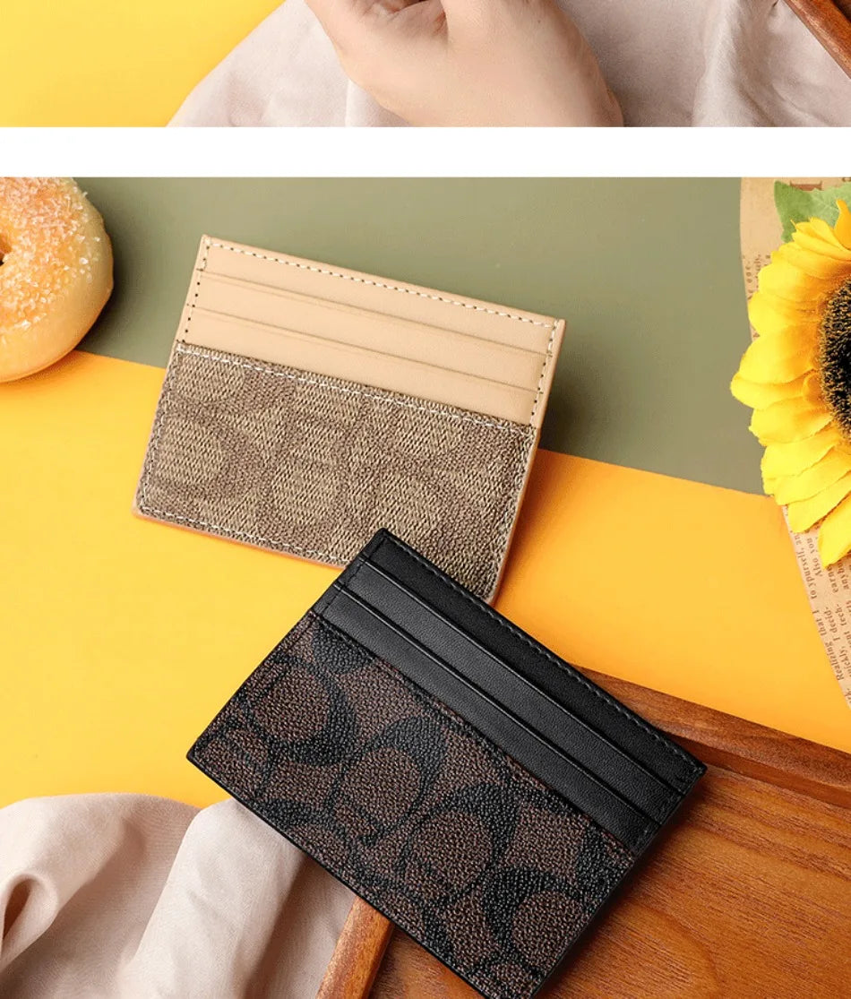A close-up of an elegant PU leather card holder purse in black and brown tones resting on a wooden surface.