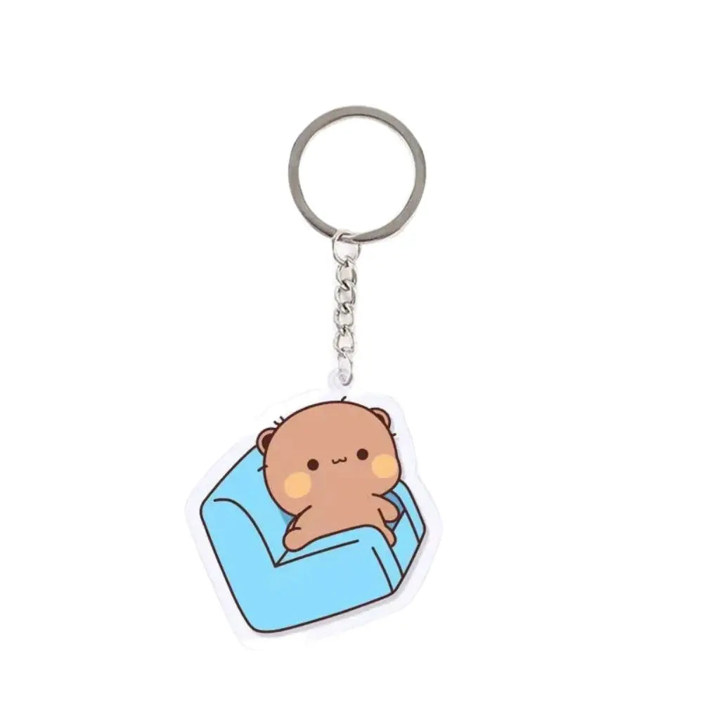 A cute brown cartoon character charm attached to a silver keyring.