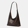 A dark brown soft PU leather retro tote bag with a zipper closure shown against a light background.