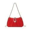 A red pleated evening clutch bag with a gold chain strap and a silver rhinestone closure.