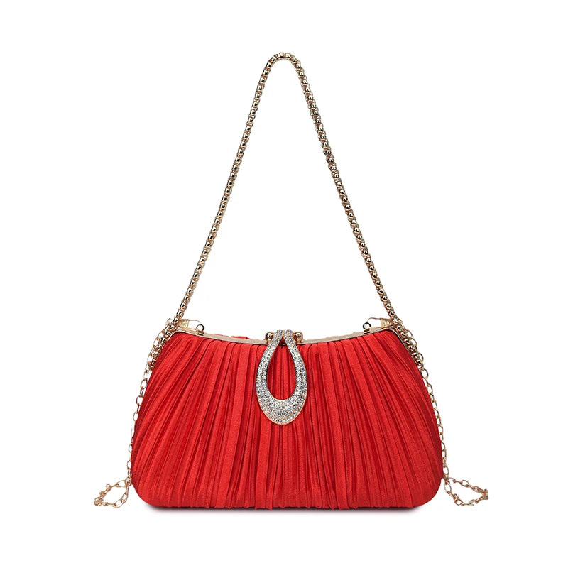 A red pleated evening clutch bag with a gold chain strap and a silver rhinestone closure.