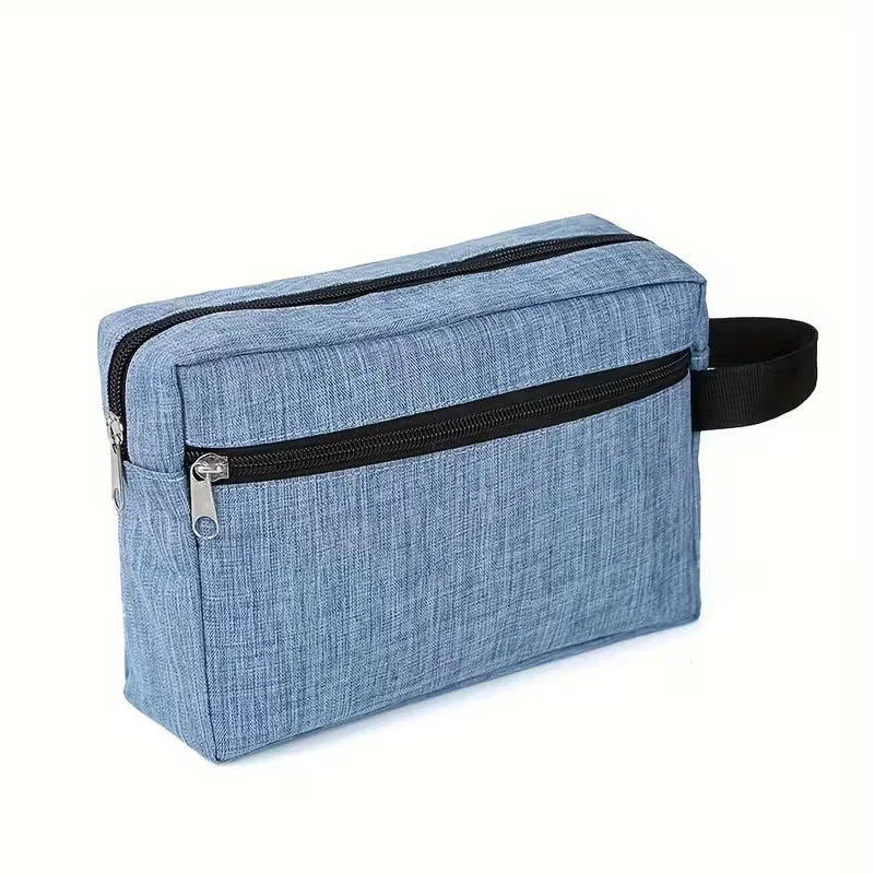 A light blue fabric toiletry bag with a black zipper and black strap.