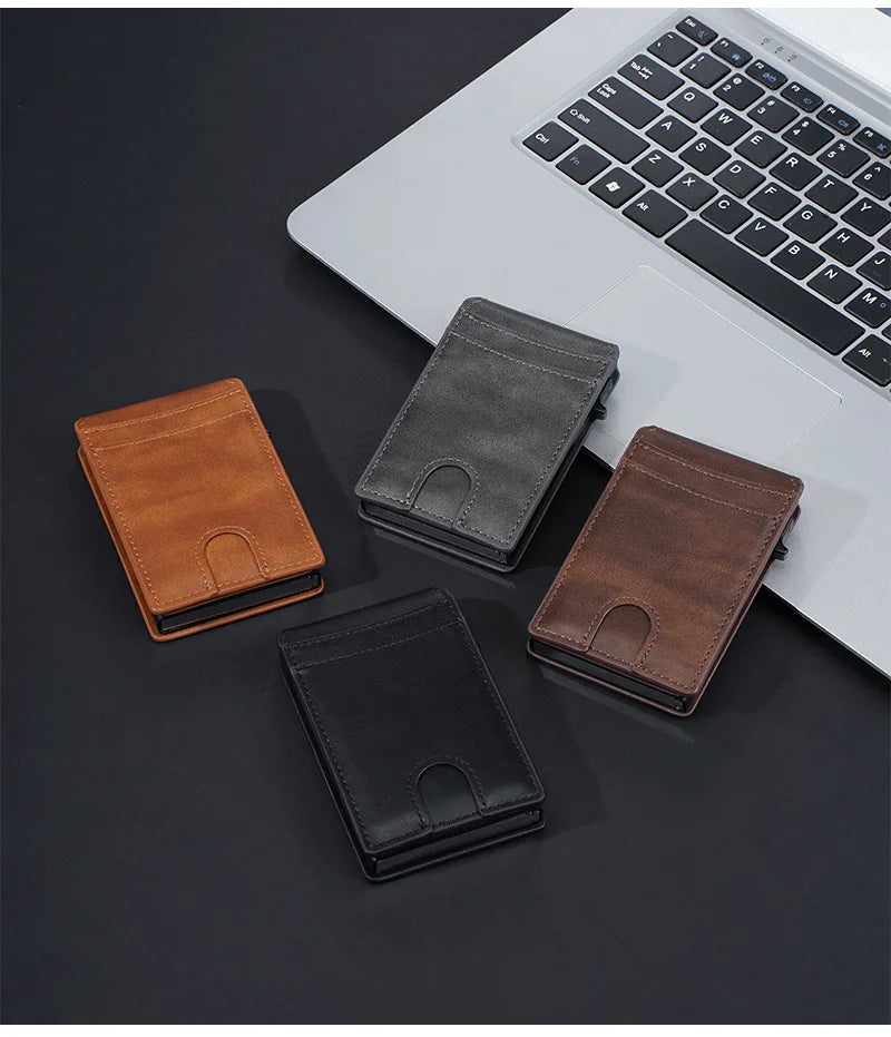 A collection of four men's PU leather card holder wallets in brown, black, and dark gray placed on a dark surface next to a l
