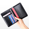 A black genuine leather RFID blocking passport holder displaying several colored cards.