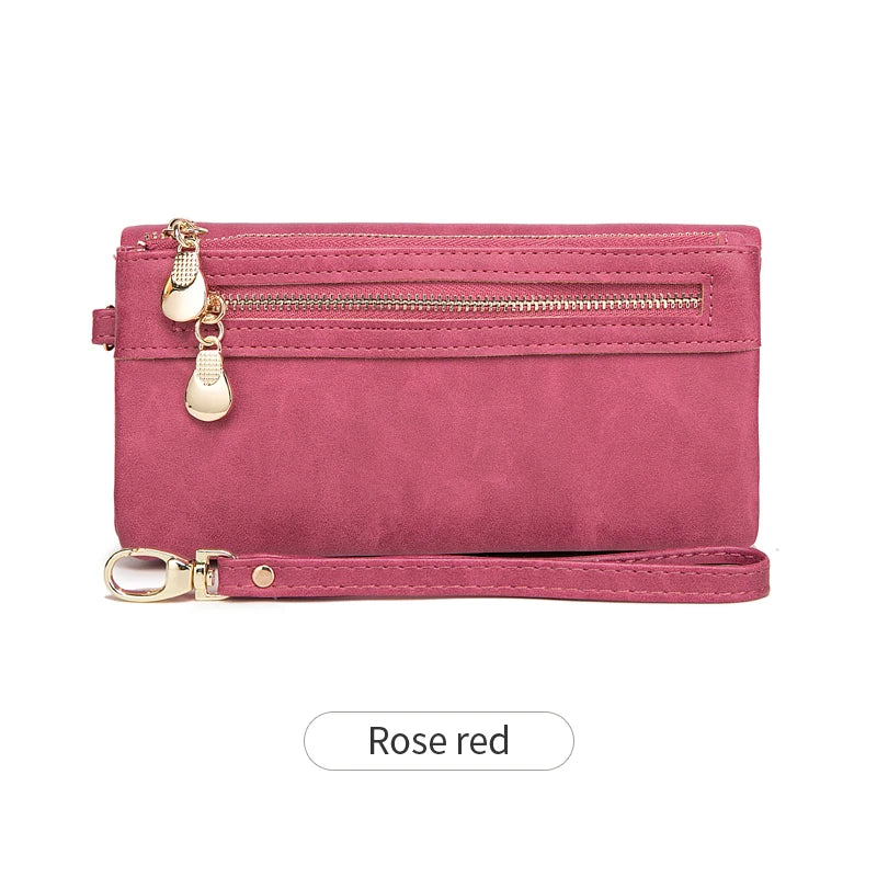 A pink retro long wallet with a gold zipper pull and a matching pink strap.