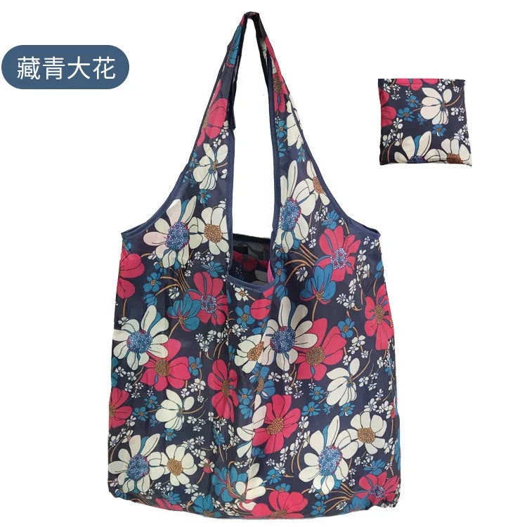 A reusable eco tote shopping bag featuring a floral pattern with blue, pink, and white flowers.