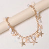 Gold layered chain necklace featuring pearl and seashell charms