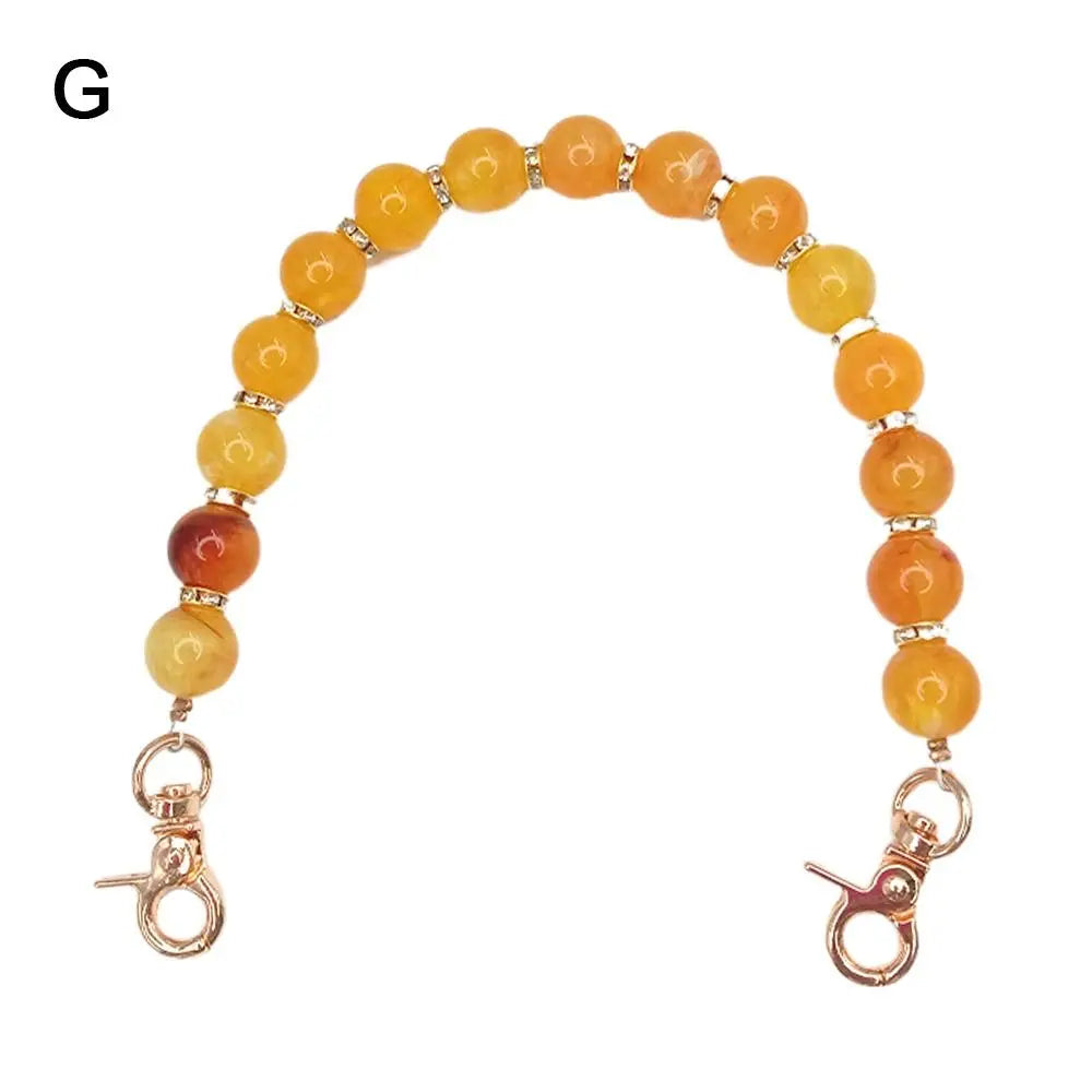 Handcrafted resin stone bead bag chain with round amber and orange colored beads