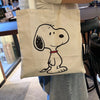 A white canvas shoulder bag featuring a black line drawing of a dog's head.