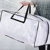 A person is holding a white heavy duty storage bag with black handles and a clear plastic lining.