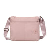 A light pink waterproof nylon crossbody bag with a flap closure and adjustable strap.