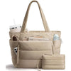 A beige quilted puffer tote bag with pockets and a matching pouch resting on a white surface.