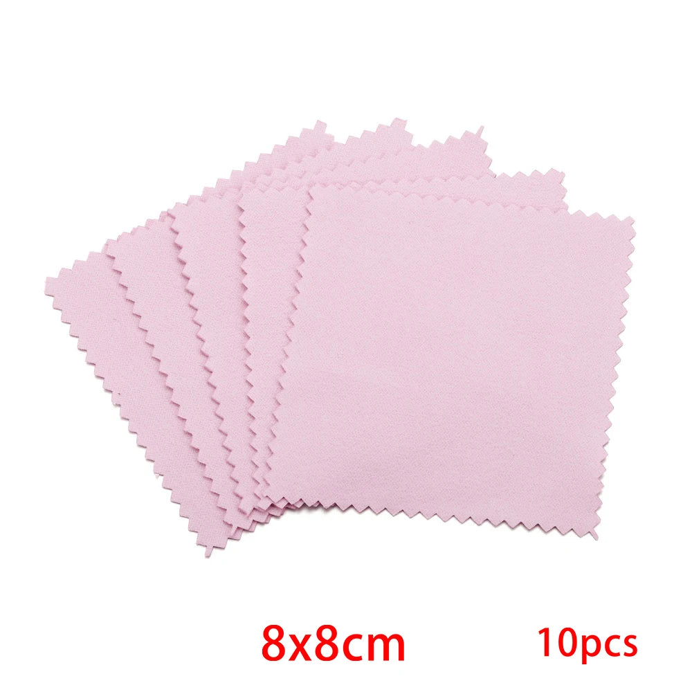 A stack of ten pink polishing cloths with serrated edges for jewelry cleaning.
