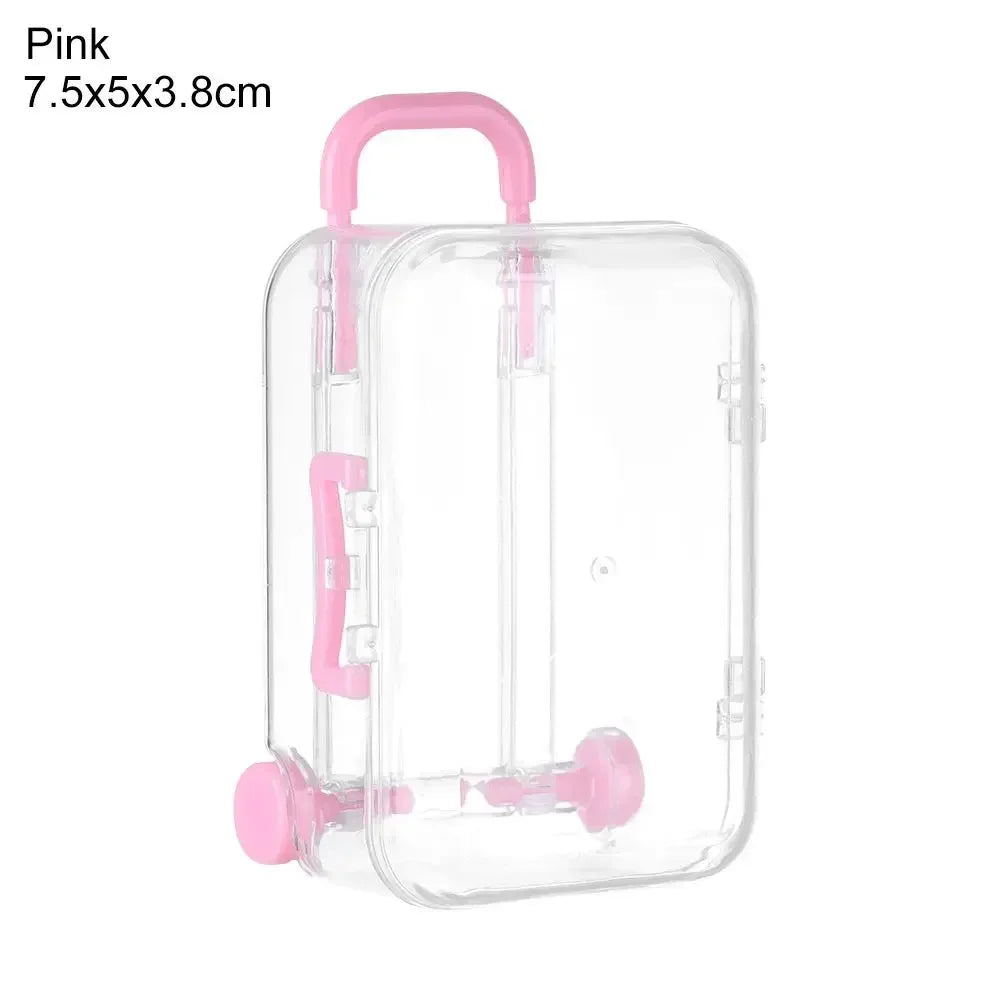 Pink miniature doll suitcase with a clear plastic body and pink handle
