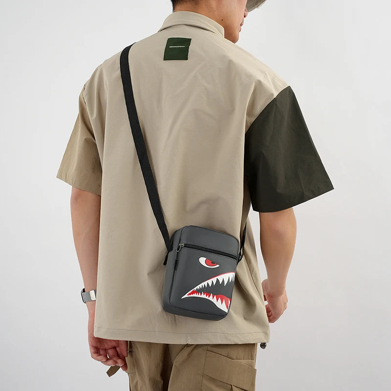 Une personne portant un t-shirt beige transporte une pochette de téléphone noire à bandoulière avec un motif dentaire rouge e