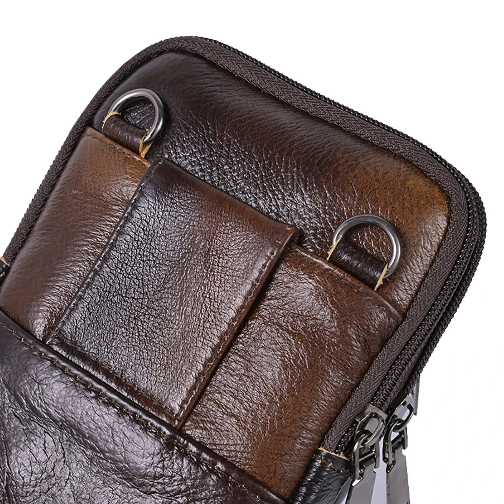 A close-up view of a brown vintage cowhide leather crossbody bag with stitched details and metal hardware.