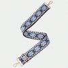 A patterned blue and white fabric strap with gold hardware, shown diagonally.