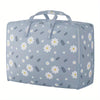 Light blue fabric storage bags with a white floral pattern, designed for storing blankets and clothes.