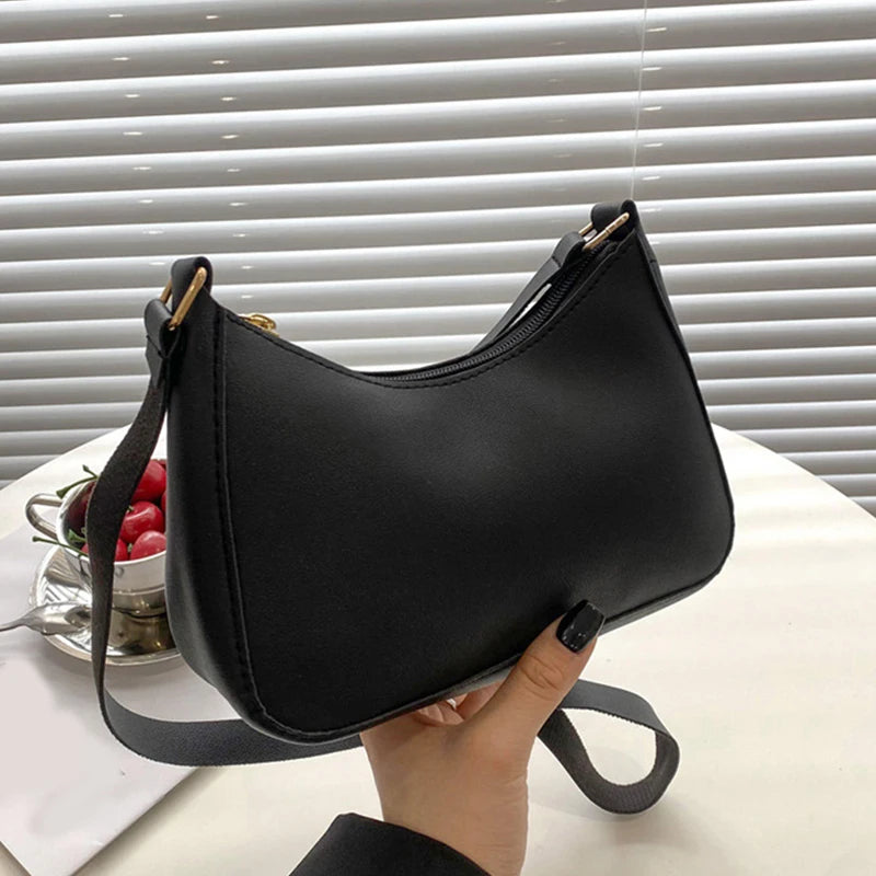 A black retro solid color PU leather shoulder bag with a strap is shown against a white background.