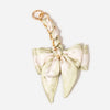 A light green and cream striped fabric bow bag chain strap extension with a gold-toned clasp.