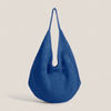 A deep blue crochet shoulder bag featuring a mesh detailing texture.