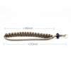 Handwoven paracord camera wrist strap in tan color with a black clasp and silver ring.