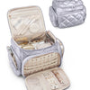 A silver quilted multi-compartment travel organizer bag with an open flap showing various cosmetic and jewelry items.