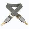 A gray canvas cotton bag strap with metal hooks shown in an X-shape.