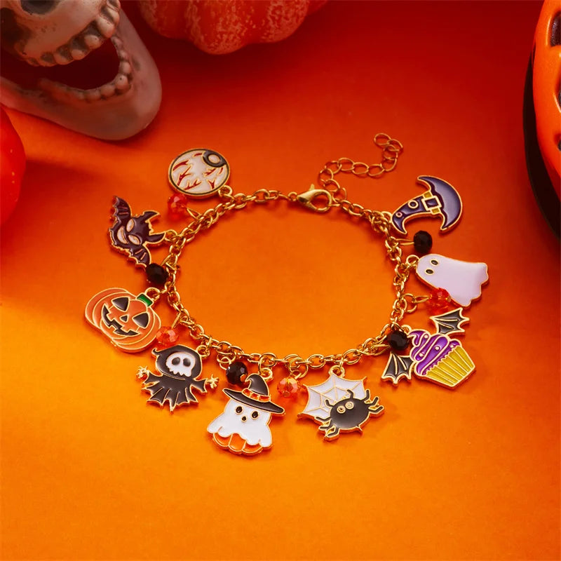 A gold charm bracelet featuring Halloween themed charms like pumpkins, ghosts, and bats on an orange background.