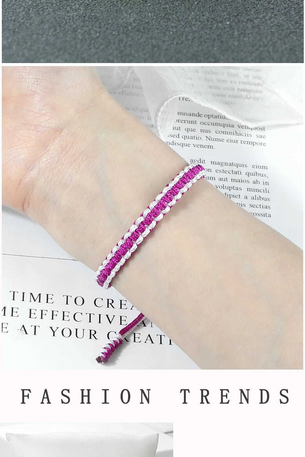 A close-up of a handmade braided rope bracelet with pink and white threads worn on a wrist.