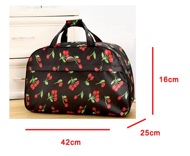A black PU leather travel duffel bag featuring a pattern of red and green berries, shown with dimensions.