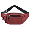 A maroon canvas waist fanny bag with a black strap and zippered pocket.