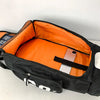 Orange and black waterproof travel gym backpack with skateboard straps open to show the interior