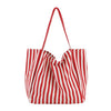 A red and white striped canvas tote bag with a drawstring top and inner pocket.